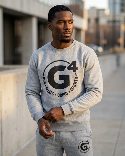 Man wearing a gray sweatshirt with 'G4' logo outdoors